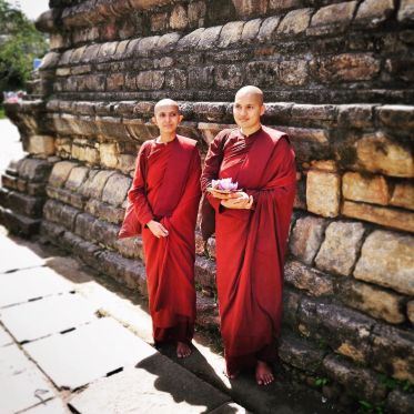 Monks_leaving_offerings_at_the_sacred_Temple_of_the_Tooth_in_Kandy__Sri_Lanka